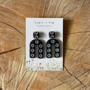 black dangling flower stamped arc polymer clay earrings